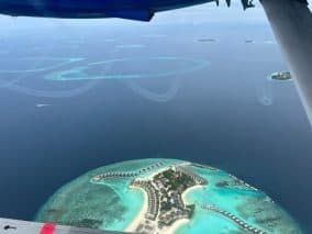 Cheap water villas with private pools in the Maldives - aerial view of the island